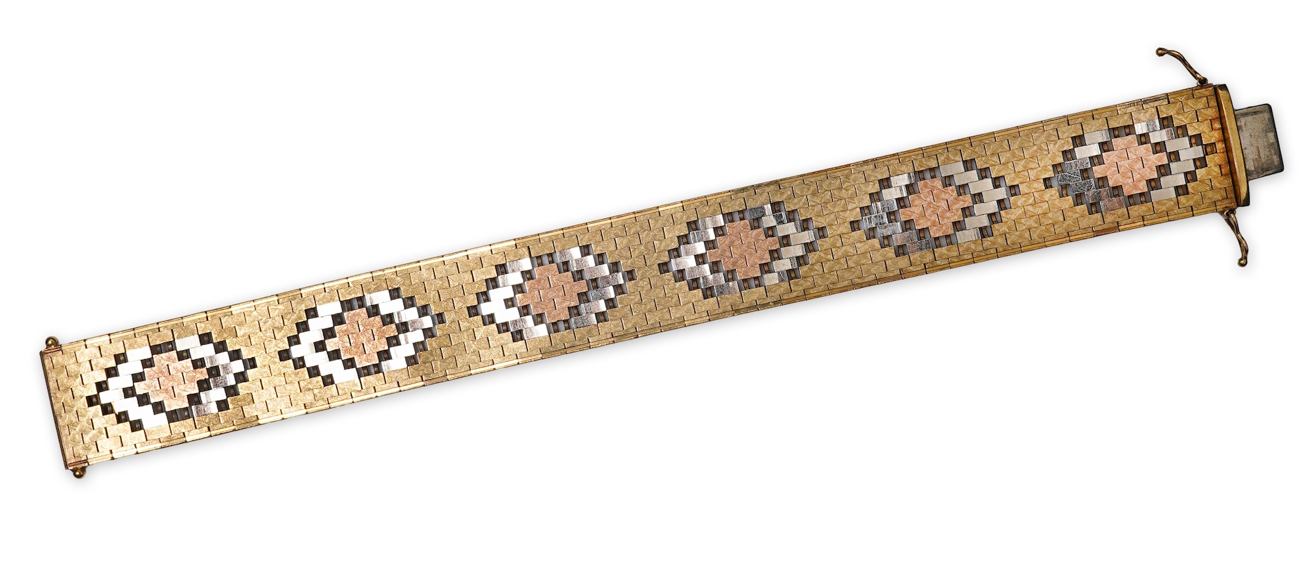 A gold bracelet, Italy, circa 1983, composed of brick linking with an engraved finish in tricoloured 9ct gold, length 18.5cm, Italian maker's mark, British import hallmarks, gross weight approximately 40.5 grams